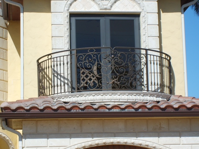Mediterranean-style residential construction with curved balcony