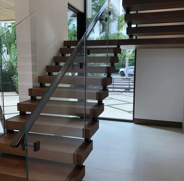Custom floating staircase with glass railing — Anatolia Construction
